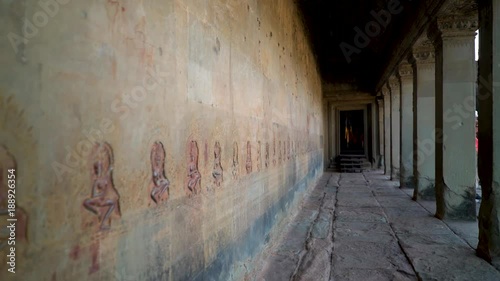 Steadicam gimbal motion down a corridor of Angkor Wat lined with bas relief apsara dancers. photo