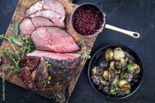 Photo Barbecue dry aged haunch of venison with mushroom and potatoes as close-up on an