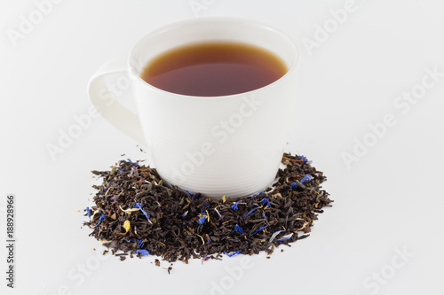 Tea cup with tea leaves isolated on white background