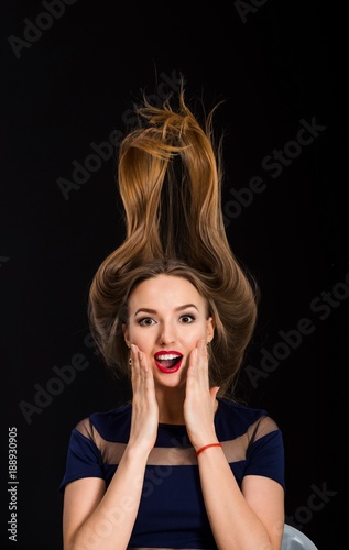 Young surprised woman isolated on black background
