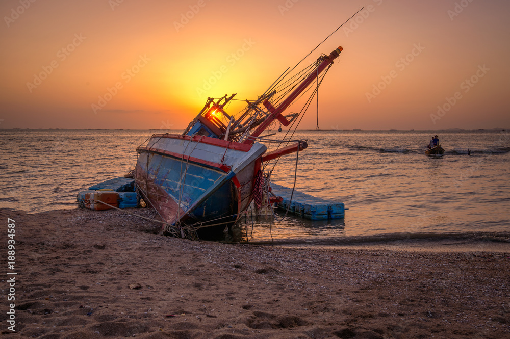 An old shipwreck or abandoned shipwreck.,Wrecked boat abandoned stand on beach or Shipwrecked off the coast of Thailand.