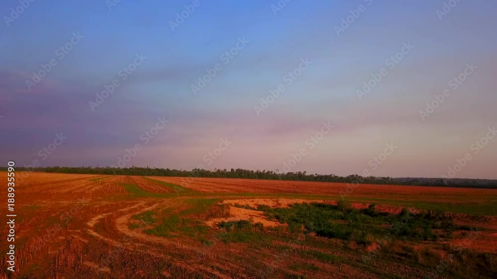 Aerial shot descending over a dry empty field Aerial shot descending over a dry empty field