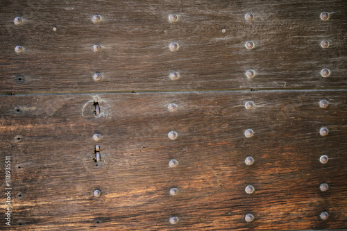 Detail of Japanese traditional wooden gates with metal rivets in Kyoto, Japan.
