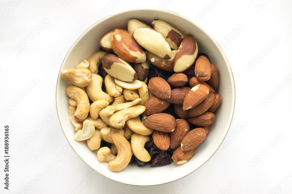 Bowl of mixed nuts (Brazil nuts, cashews and almonds) in a little bowl on the white background Bowl of mixed nuts (Brazil nuts, cashews and almonds) in a little bowl on the white background