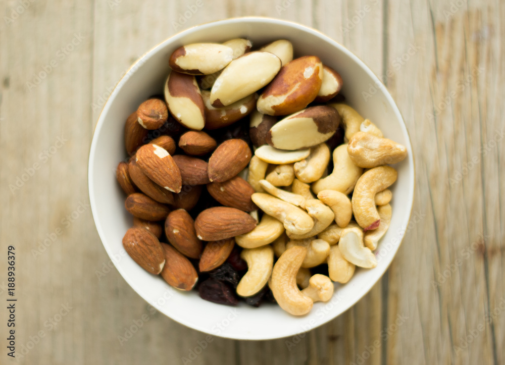 Bowl of mixed nuts on the wooden background, wooden table Bowl of mixed nuts on the wooden background, wooden table