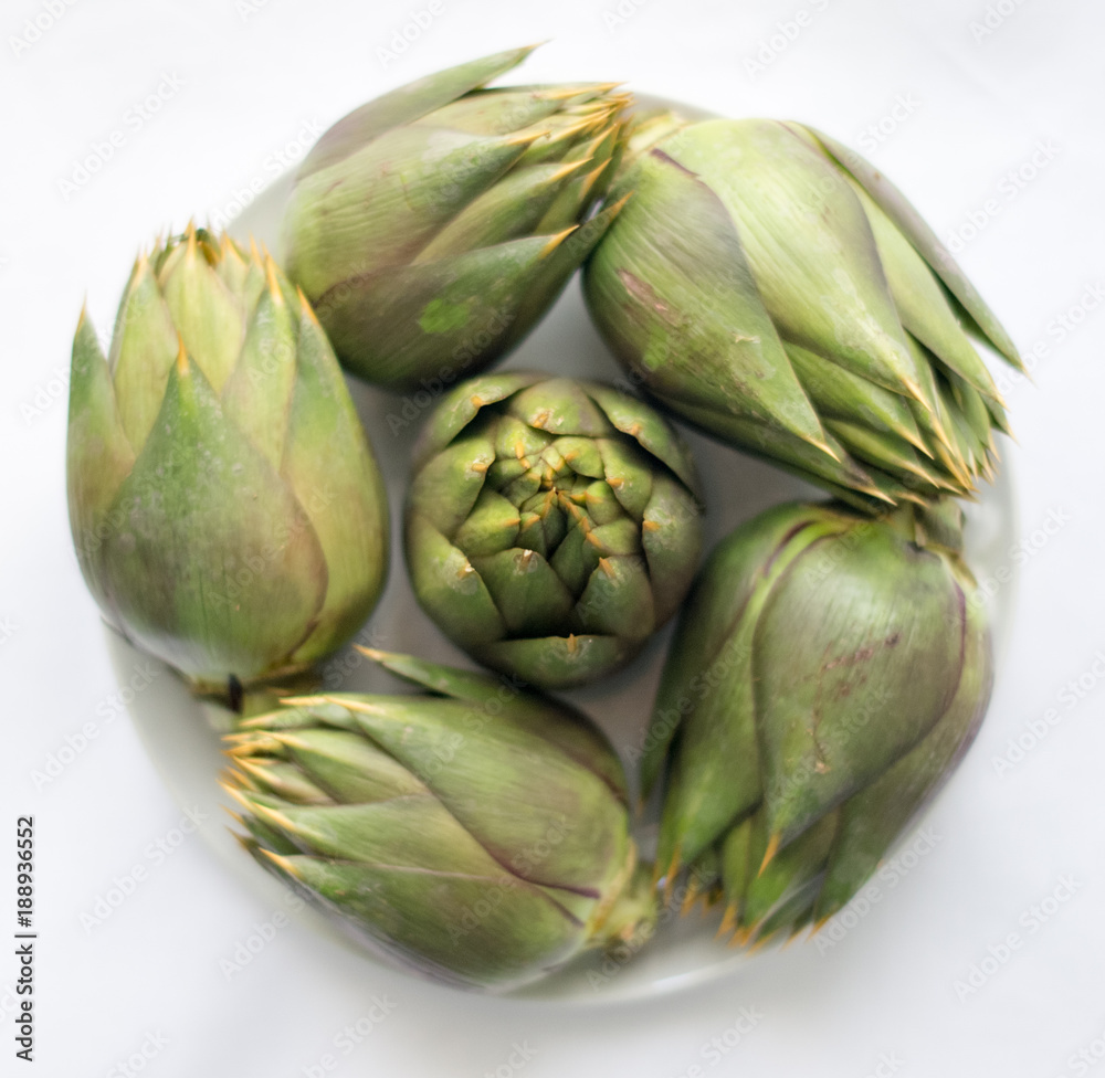 Fototapeta premium Five artichokes on the white background