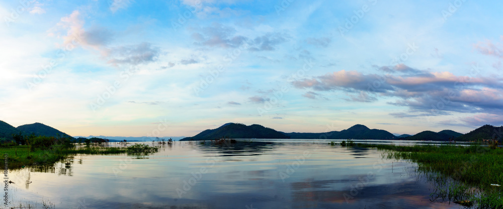 panorama landscape view of amazing beautiful island and water with blue sky and cloud when twilight in srinakarin dam,kanjanaburi,thailand. great scene of nature in the evening. panorama landscape view of amazing beautiful island and water with blue sky and cloud when twilight in srinakarin dam,kanjanaburi,thailand. great scene of nature in the evening.