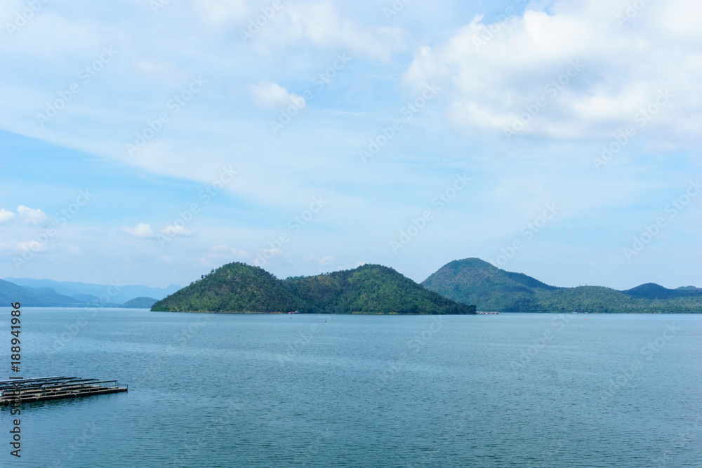 panorama landscape view of amazing beautiful island and water with blue sky and cloud when twilight in srinakarin dam,kanjanaburi,thailand. great scene of nature in the evening.