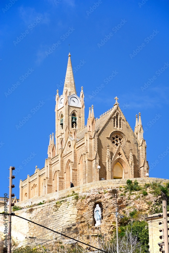 View of Our Lady of Lourdes church on the hillside, Mgarr, Gozo, Malta.