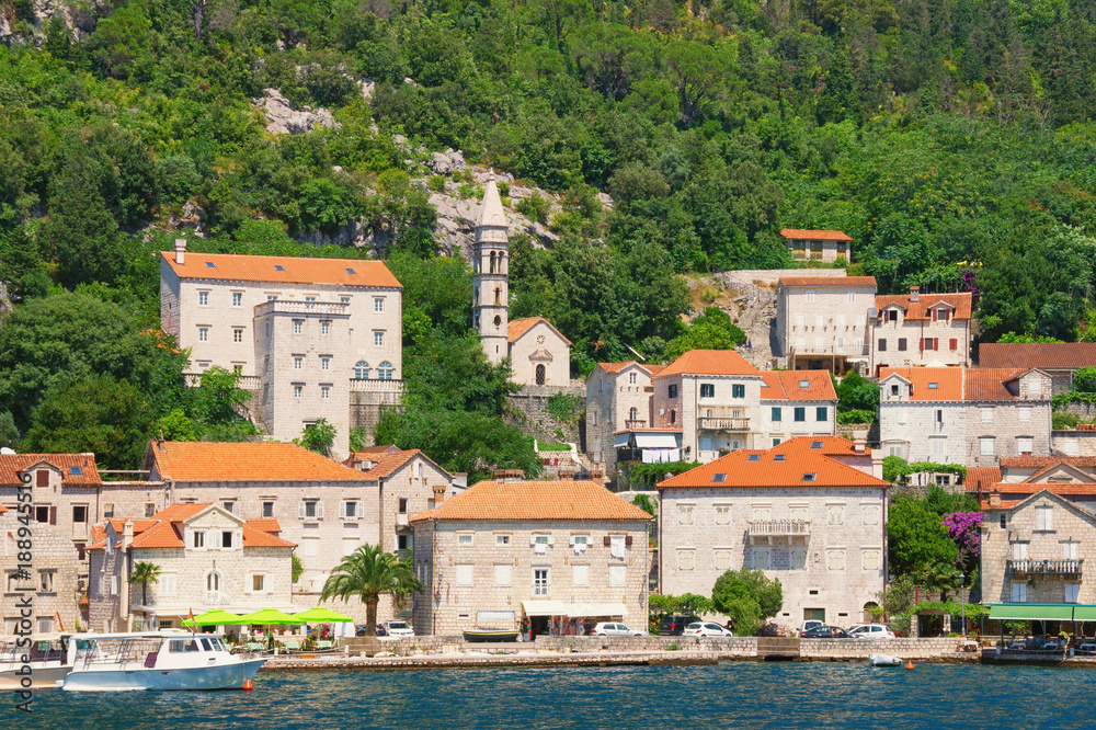 View of old town of Perast with ancient stone palaces and Church of Our Lady of Rosary. Bay of Kotor, Montenegro, summer
