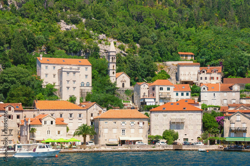 View of old town of Perast with ancient stone palaces and Church of Our Lady of Rosary. Bay of Kotor, Montenegro, summer
