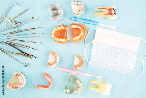 dentist tools and prosthodontic on color background, flat lay, top vipw.