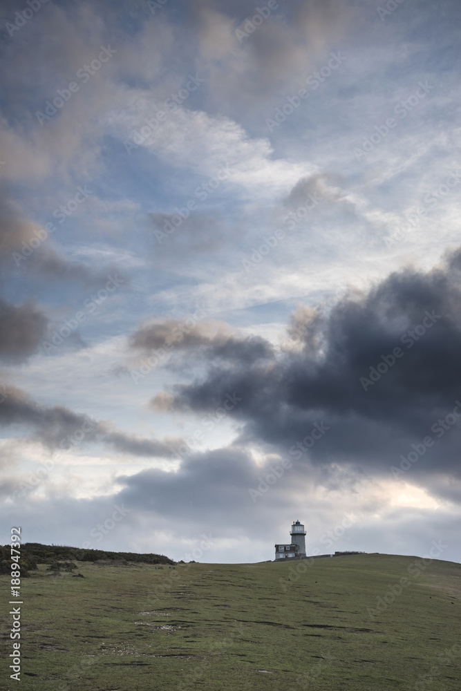 Stunning landscape image of Belle Tout lighthouse on South Downs National Park during stormy sky