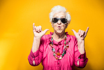 Grandmother colored portraits set in the studio. Concepts about seniority and third age. Funny old woman making party and celebrate 