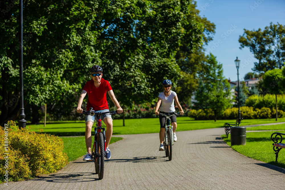 Healthy lifestyle - people riding bicycles in city park