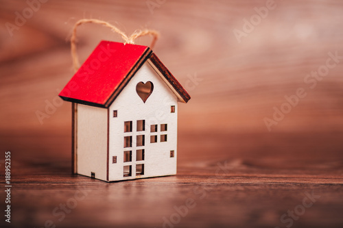 Valentine's day. House symbol on a brown wooden background

