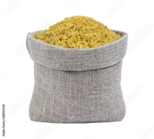 Dry bulgur wheat in bag isolated on white