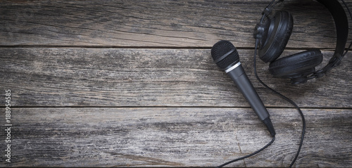 Microphone and headphone on a wooden background