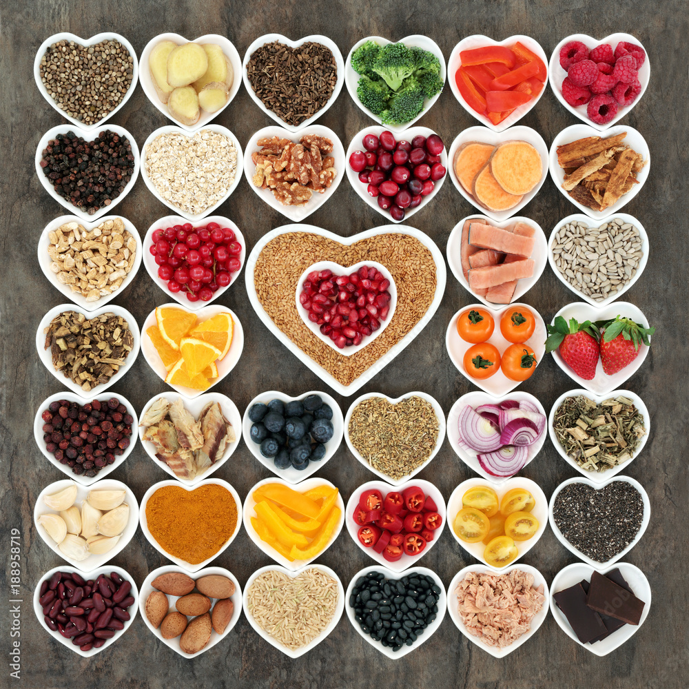 Health food for a healthy heart with vegetables, fruit, fish, nuts, seeds, grain, cereals with herbs and spices used in herbal medicine. High in omega 3 fatty acids, fibre, antioxidants and minerals Health food for a healthy heart with vegetables, fruit, fish, nuts, seeds, grain, cereals with herbs and spices used in herbal medicine. High in omega 3 fatty acids, fibre, antioxidants and minerals