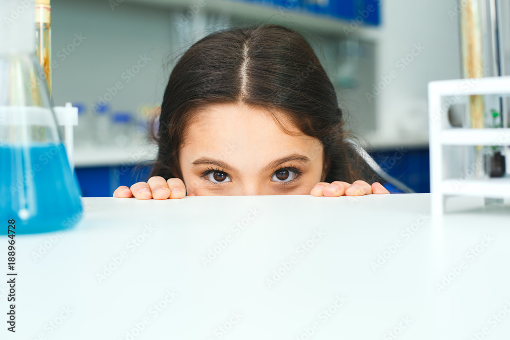 Little child with learning class in school laboratory hiding Little child with learning class in school laboratory hiding