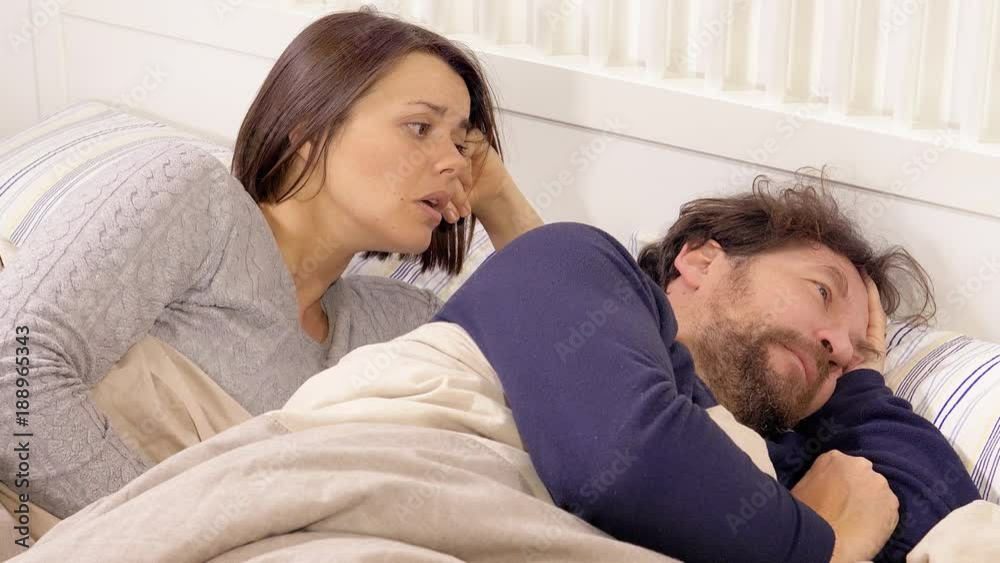 Couple in bed wife asking to forgive husband angry closeup Couple in bed wife asking to forgive husband angry closeup