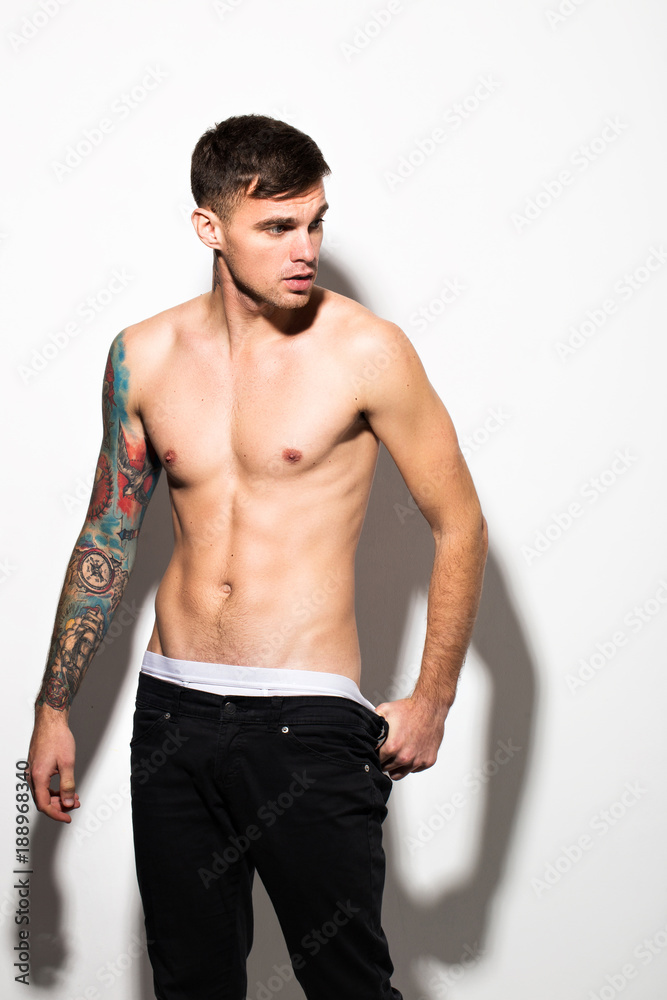 Muscular beautiful sexy guy with tattoos on body posing, isolated on white  Stock Photo | Adobe Stock