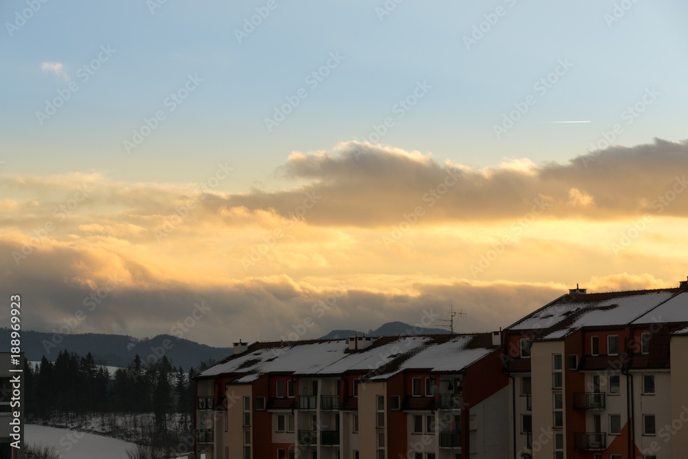 Sunset in the town during winter with snow on the roofs. Slovakia	