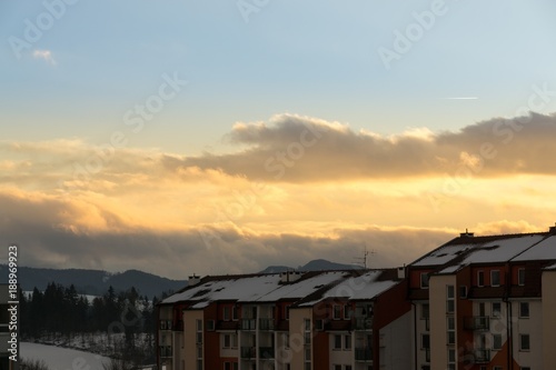 Sunset in the town during winter with snow on the roofs. Slovakia 