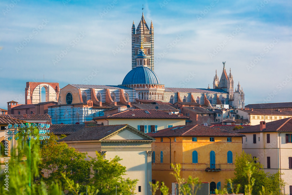 Fototapeta premium Beautiful view of Dome and campanile of Siena Cathedral, Duomo di Siena, and Old Town of medieval city of Siena in the sunny day, Tuscany, Italy