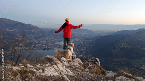 Uomo con il cane osserva il panorama la sera