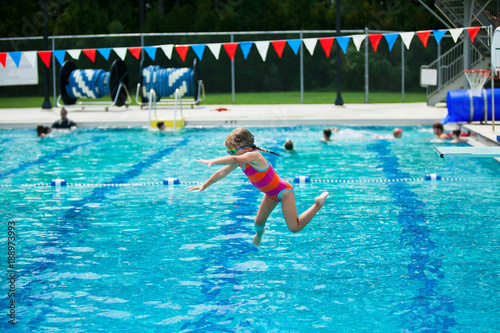 Fototapeta Naklejka Na Ścianę i Meble -  Little Girl Swim Lessons off Diving Board