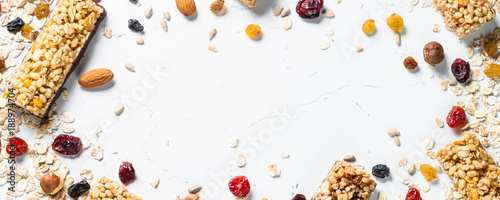 Granola bar with nuts, fruit and berries on white.