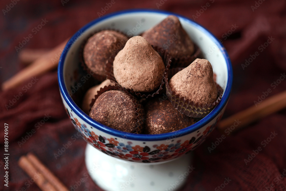 Homemade chocolate truffles with mint sprinkled with cocoa powder, selective focus Homemade chocolate truffles with mint sprinkled with cocoa powder, selective focus