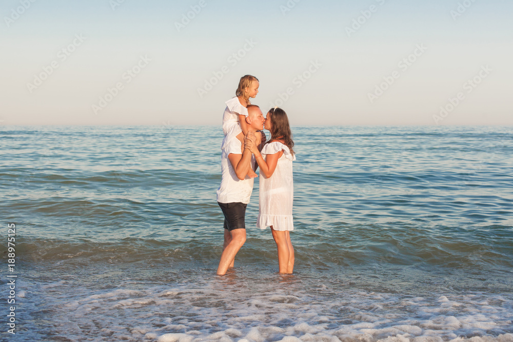 Father, mother and daughter on the seashore. Father, mother and daughter on the seashore.