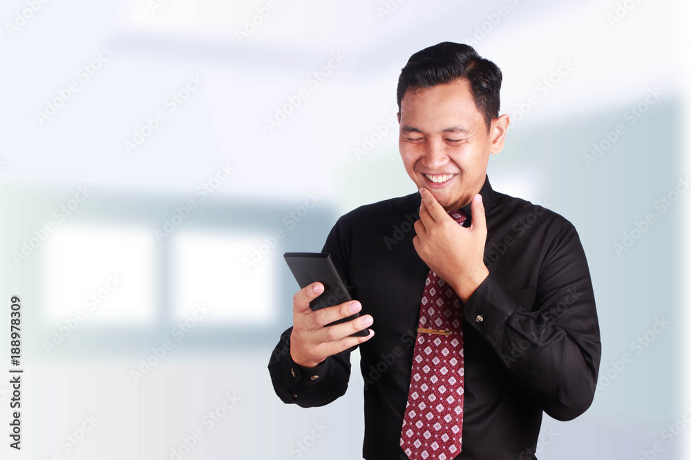 Businessman Smiling Looking at His Cellphone Businessman Smiling Looking at His Cellphone