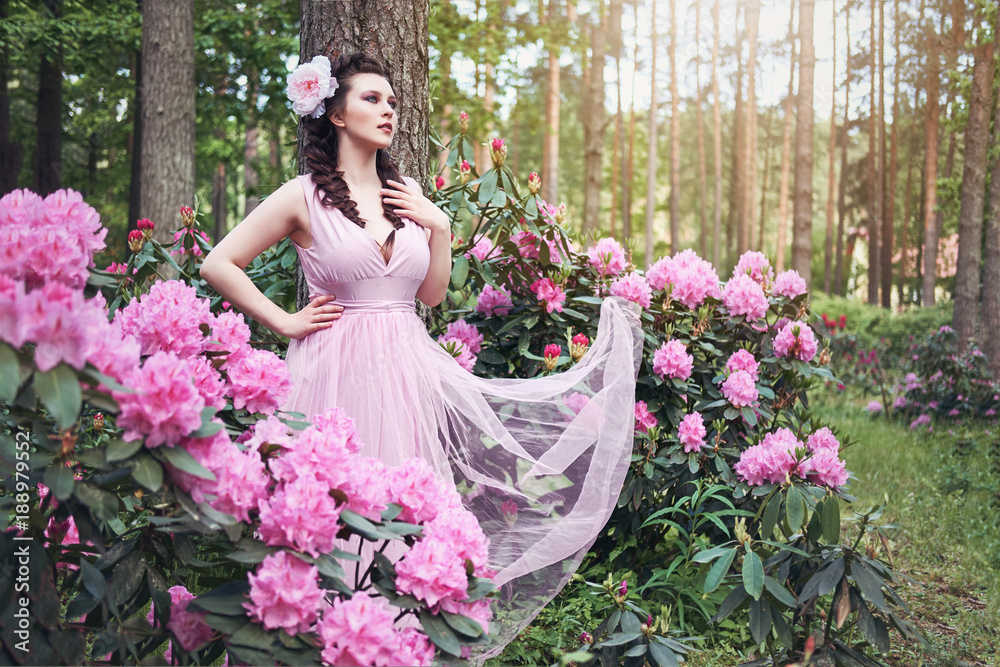 Fototapeta premium girl in dress in rhododendron garden