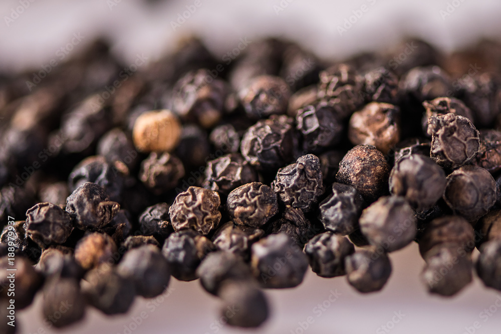 close up detail whole peppercorn on white background with low focus close up detail whole peppercorn on white background with low focus