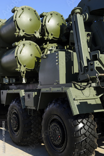 Heavy missile launcher on powerful army truck  rear view  modern military industry  antiaircraft forces  blue sky on background 