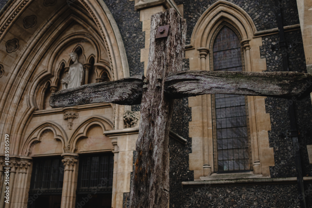 Wooden cross in front of a cathedral
