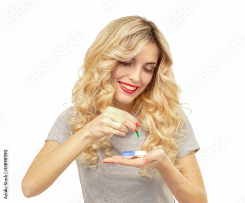 Beautiful blond woman with contact lenses box.