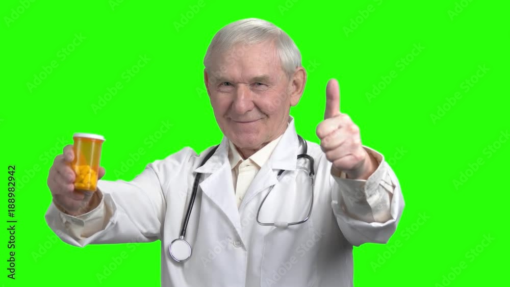 Pointing at the can of pills. Cheerful doctor advices you to take pills, green hromakey background. Pointing at the can of pills. Cheerful doctor advices you to take pills, green hromakey background.