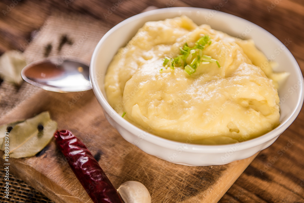 mash potatos in a white porcelain bowl on wood table mash potatos in a white porcelain bowl on wood table