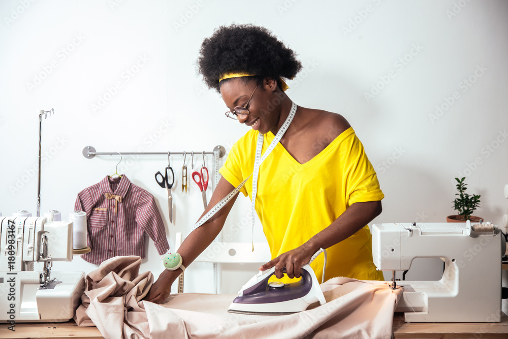 African Woman Seamstress Ironing Cloth Stock Photo, Picture and