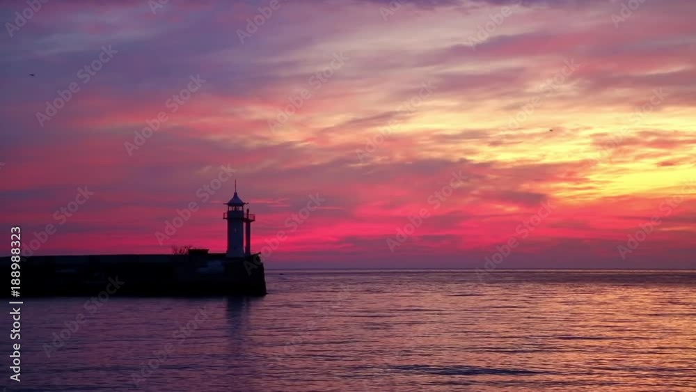 View of the lighthouse at dawn standing on the coast View of the lighthouse at dawn standing on the coast