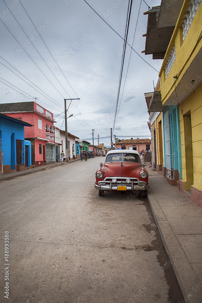 Street view with classic car in Cinefuegos, Cuba