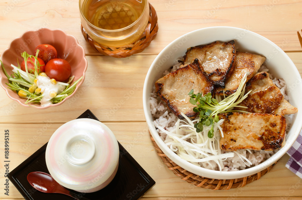 Originated in Hokkaido, Butadon, often literally translated into English as pork bowl, is a Japanese dish consisting of a bowl of rice topped with pork simmered in a mildly sweet sauce.