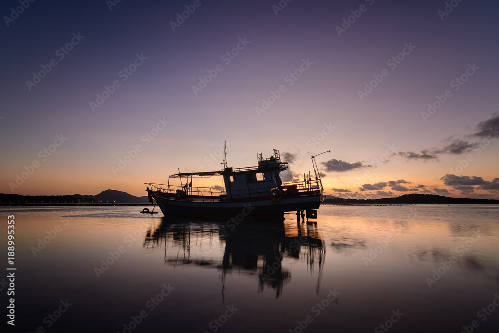 Fisherman boat in a beautiful view on the sea at sunrise