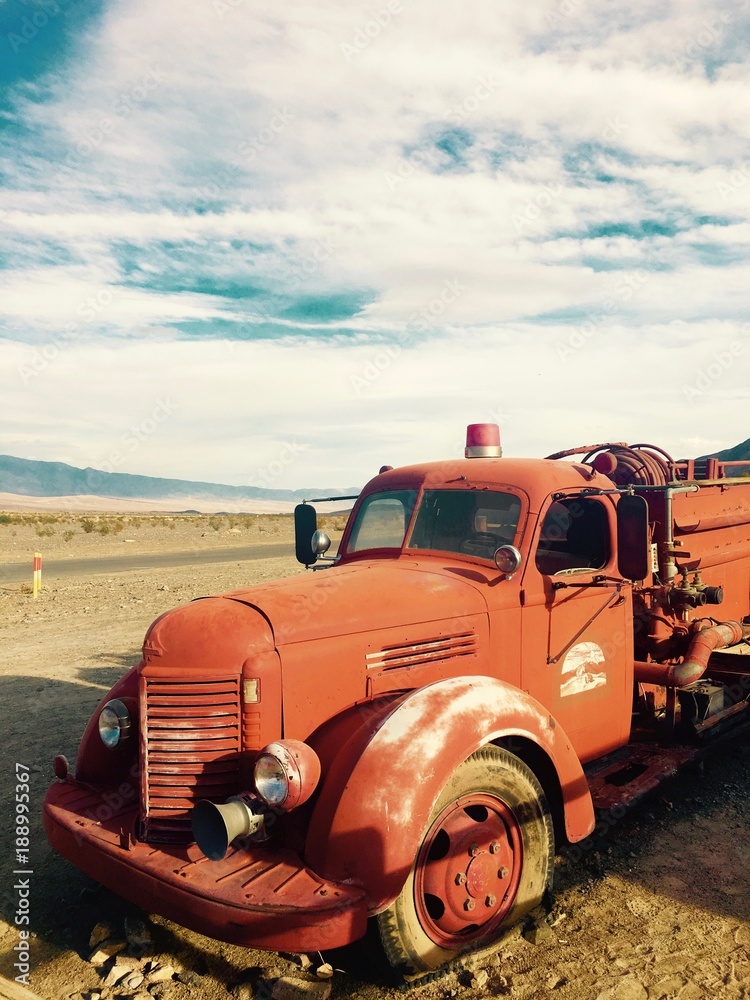 Abandoned red fire truck at Stovepipe wells in the Death Valley desert in California Abandoned red fire truck at Stovepipe wells in the Death Valley desert in California