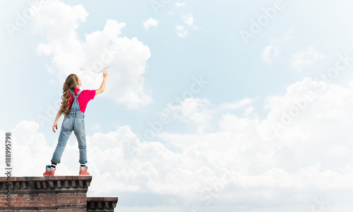 Concept of careless happy childhood with girl dreaming to become pilot