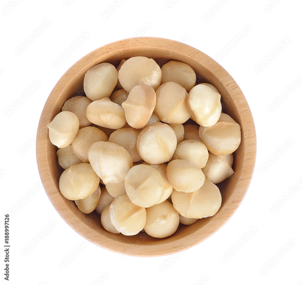 Macadamia nut in wooden bowl isolated on white background Macadamia nut in wooden bowl isolated on white background